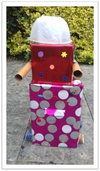 A large three box android with a dome over it's head, tube arms and a roller to move on