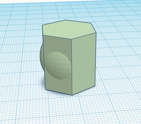 A green hexagonal prism with circular bumps on three adjacent sides