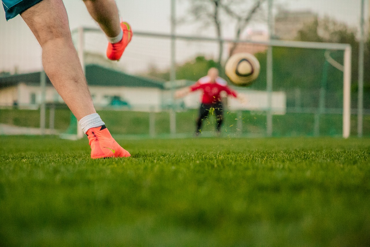 A football being kicked towards a goal