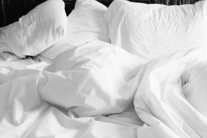 A heap of white pillows and duvets