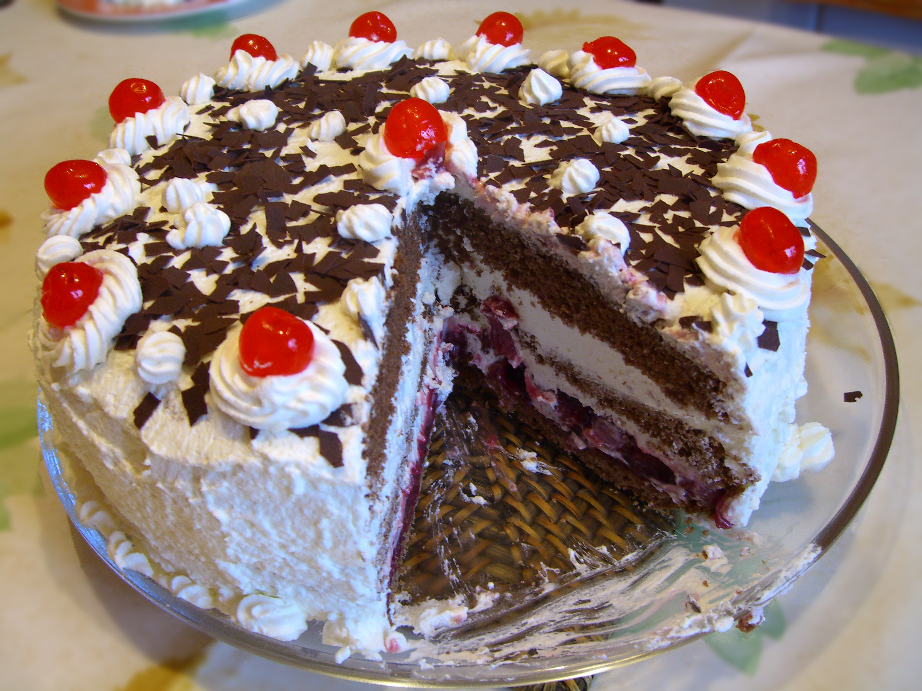Chocolate cake with cream and cherries